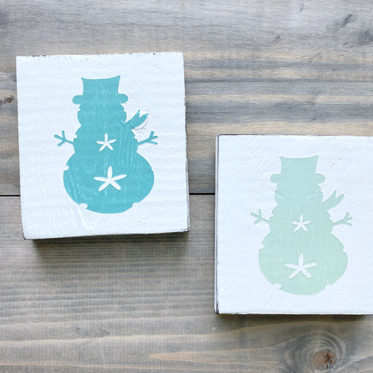 Coastal Christmas Decor, Anchored Soul Designs Sand Dollar Snowman wood sign white background with aqua and mint design, beach house holiday decor coastal design