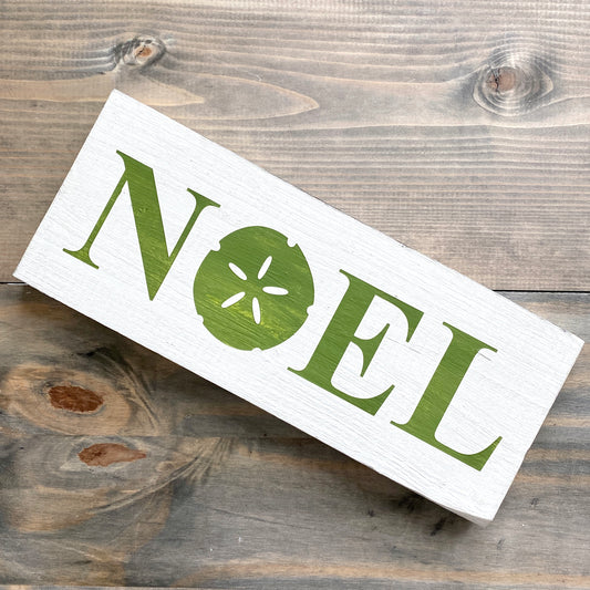 Coastal Christmas Decor, Anchored Soul Designs Noel Sand Dollar Christmas wood sign white background with green design, beach house holiday decor coastal design