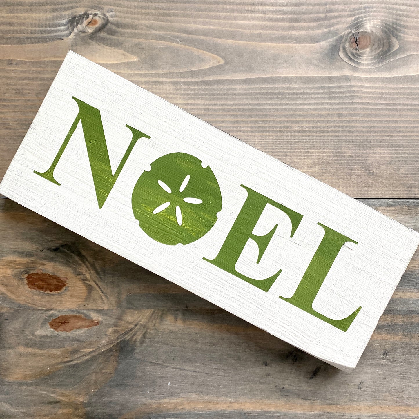 Coastal Christmas Decor, Anchored Soul Designs Noel Sand Dollar Christmas wood sign white background with green design, beach house holiday decor coastal design