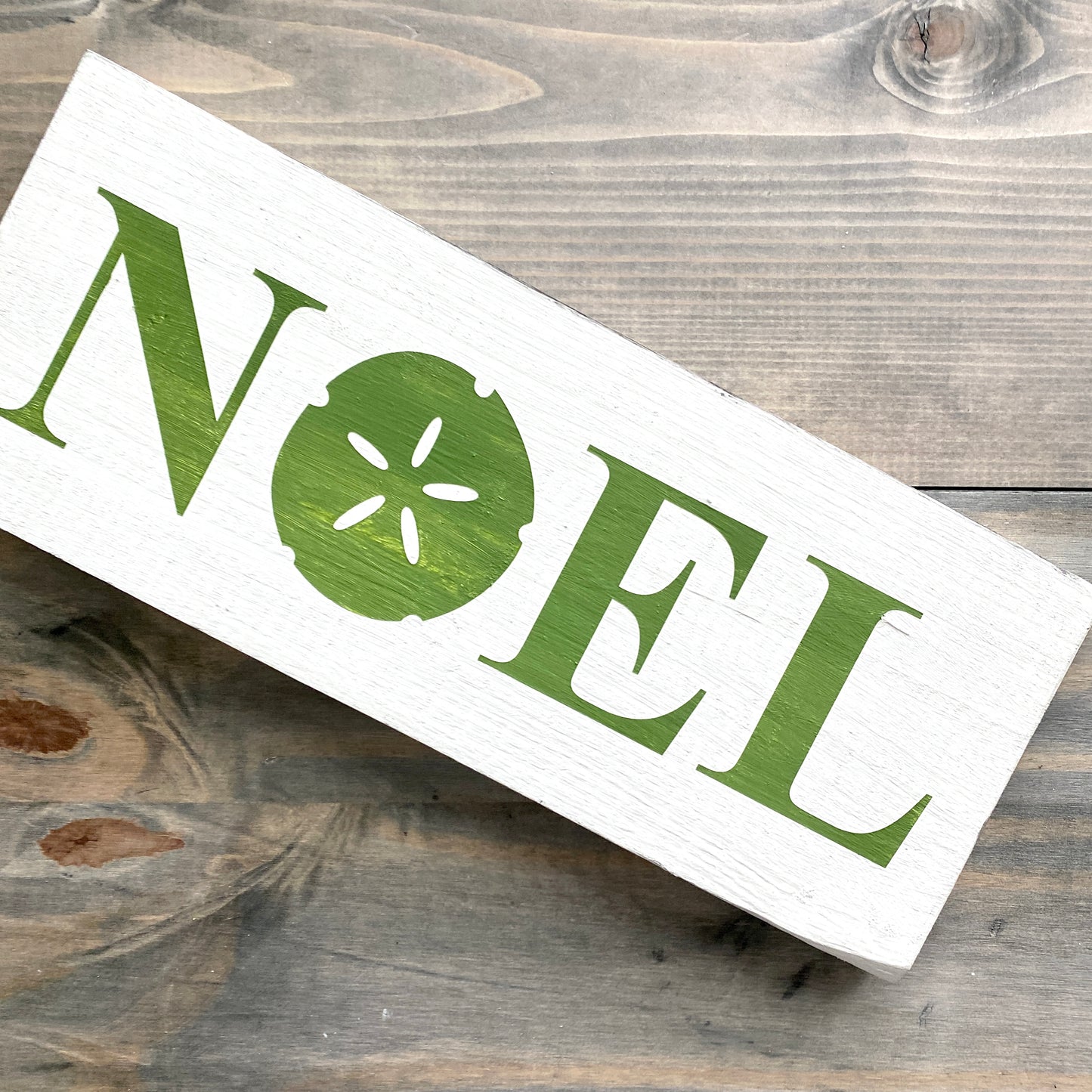 Coastal Christmas Decor, Anchored Soul Designs Noel Sand Dollar Christmas wood sign white background with green design, beach house holiday decor coastal design