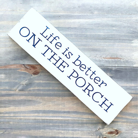 Wooden sign with 'Life is better on the porch' text on a rustic wooden surface