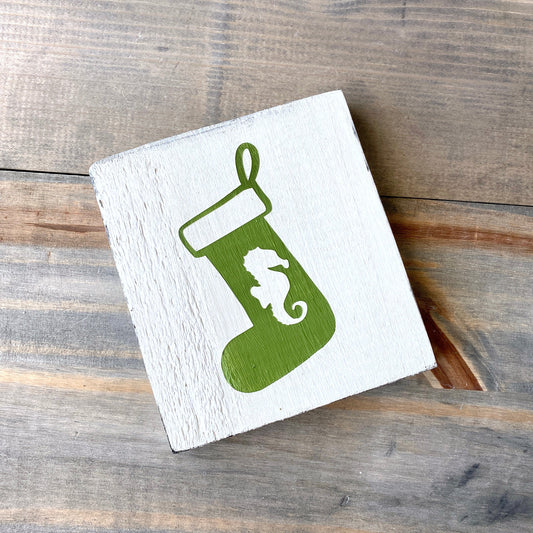 Seahorse Stocking Sign Coastal home decor and inspiration for the beach lover, gifts from Anchoredsouldesigns, coastal seahorse stocking sign in white with a green stocking and seahorse design