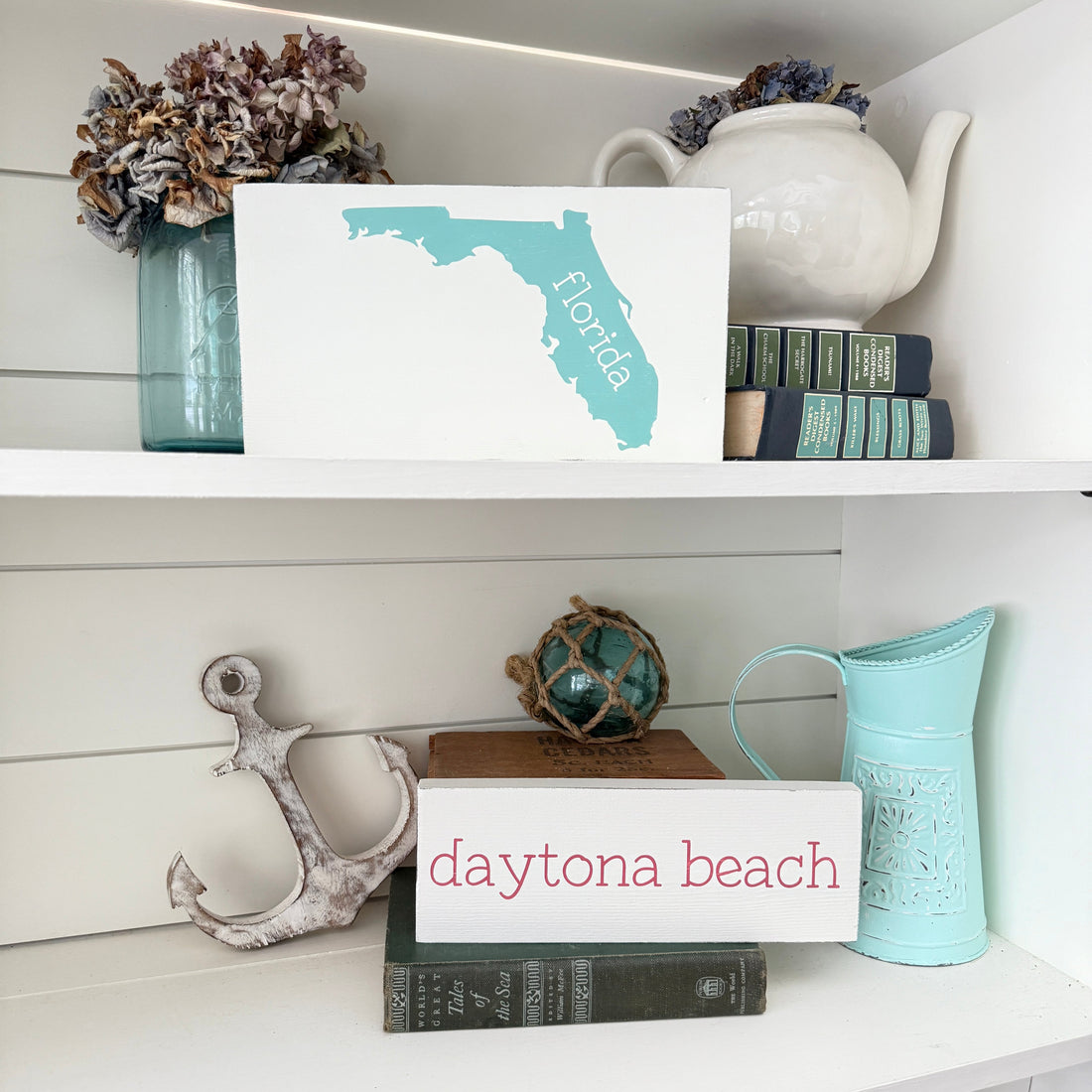 which companies offer custom beach inspired wall art prints, custom location signs for coastal home decor, florida sign and daytona beach sign on a shelf with beach decor