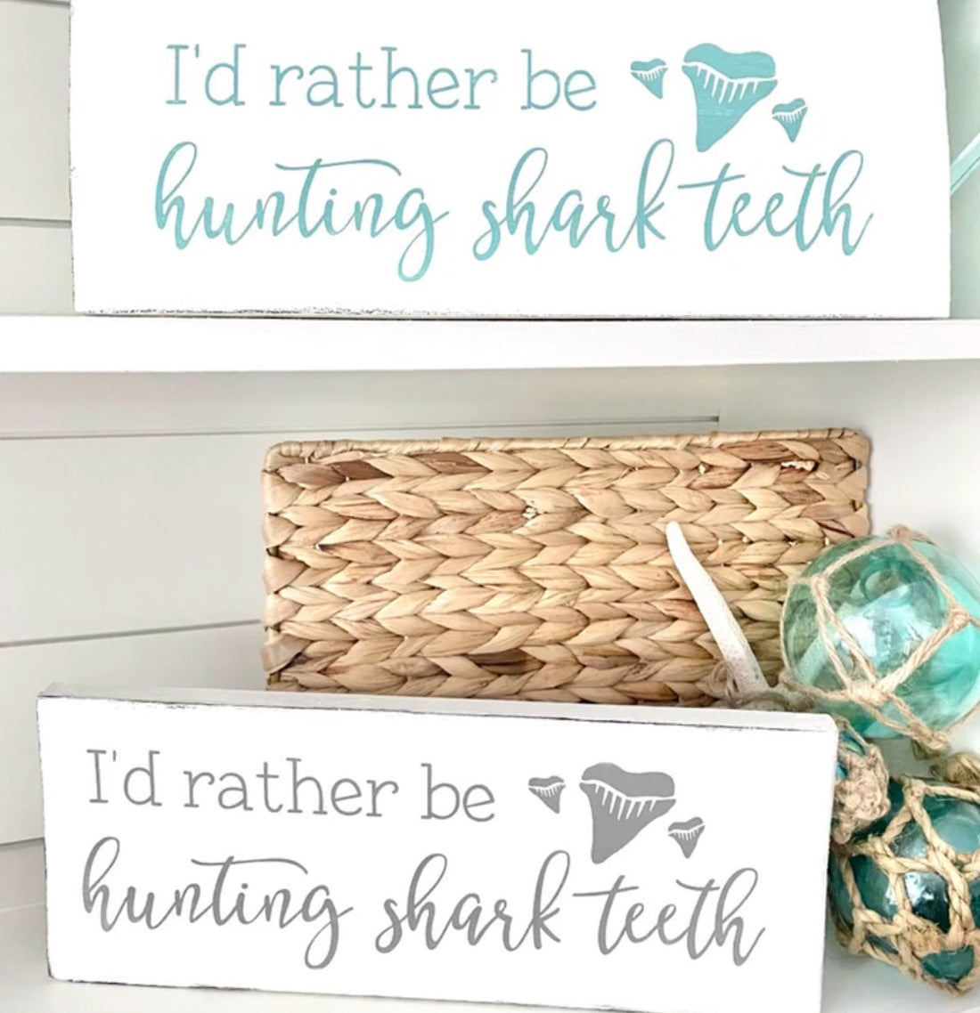Shark tooth collection displayed with handmade coastal signs and beach decor on Amelia Island