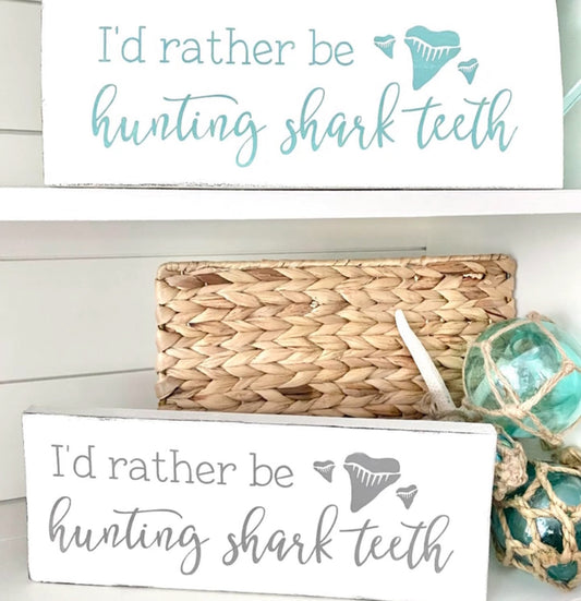Shark tooth collection displayed with handmade coastal signs and beach decor on Amelia Island