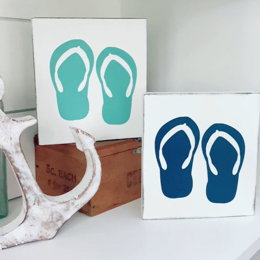 Handmade beach-inspired coastal signs including anchor, whale, and sand dollar designs for ocean-inspired home decor