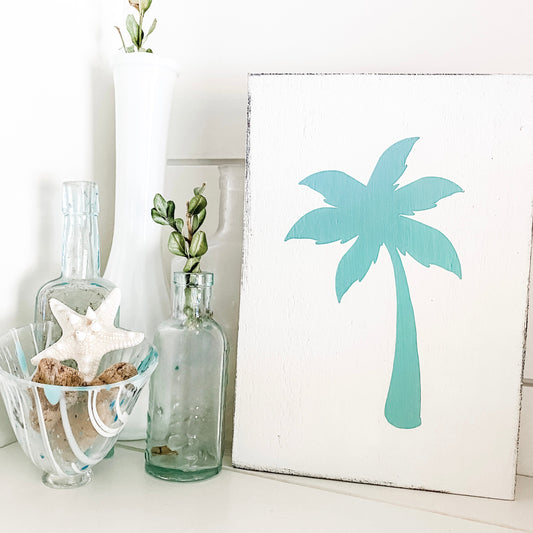How to decorate a beach house, coastal home decor, palm tree sign and a glass with driftwood and starfish