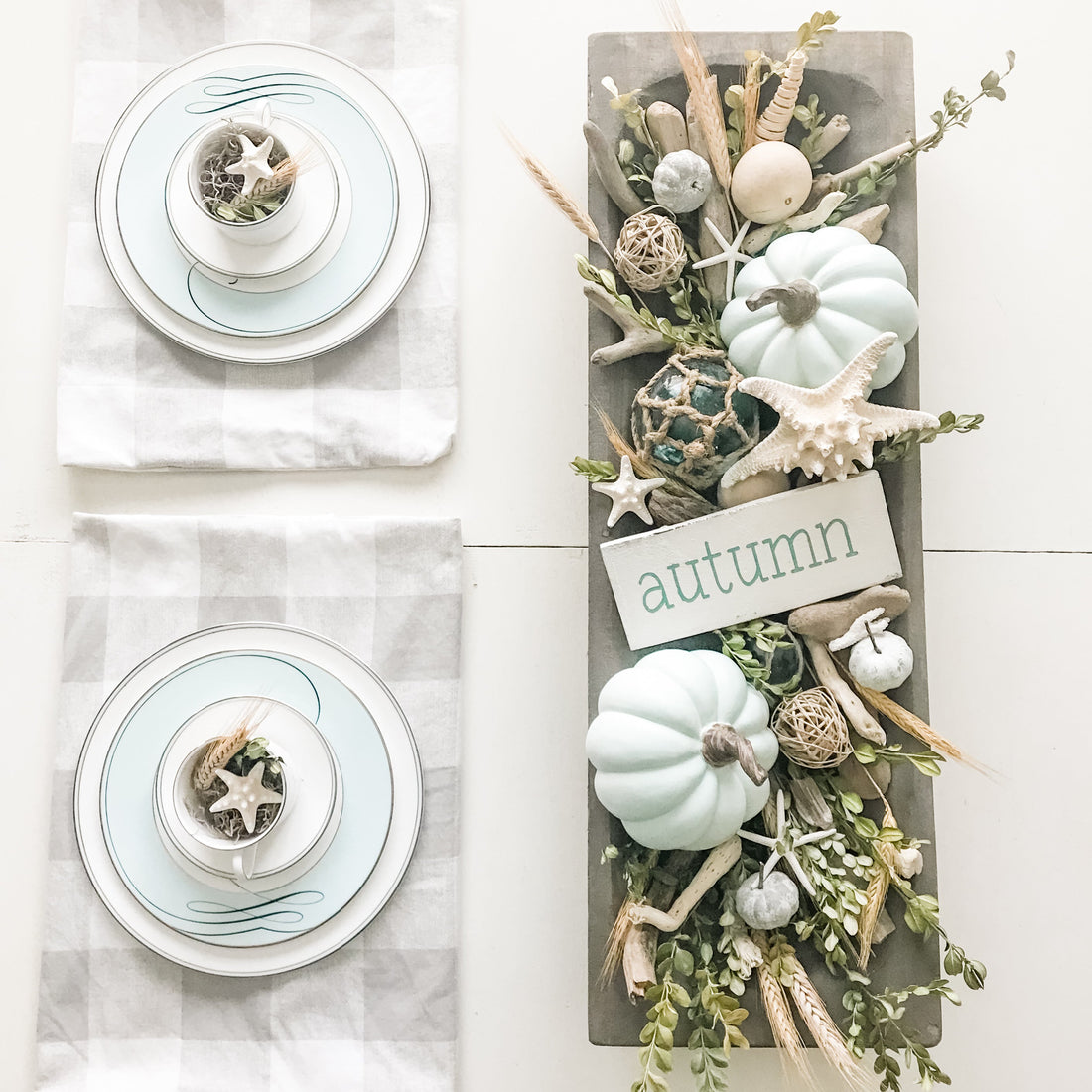 Coastal fall dough bowl centerpiece with seafoam and white pumpkins, wheat, driftwood, starfish, and a Custom Fall Word Sign from Anchored Soul Designs on a farmhouse dining table