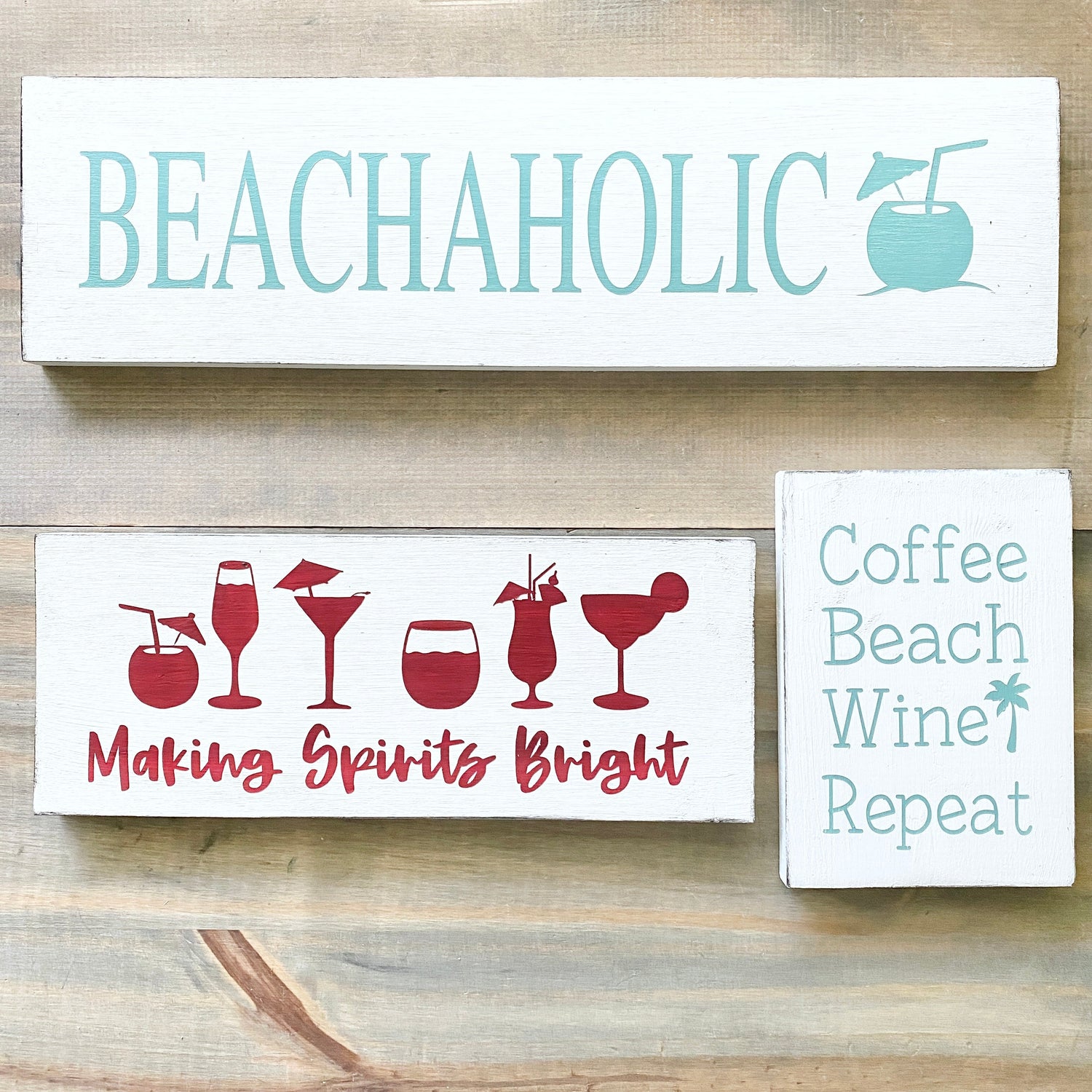 Handcrafted coastal bar signs including a Beachaholic coconut drink sign, Making Spirits Bright cocktail sign, and Coffee Beach Wine Repeat sign displayed on a weathered wood surface