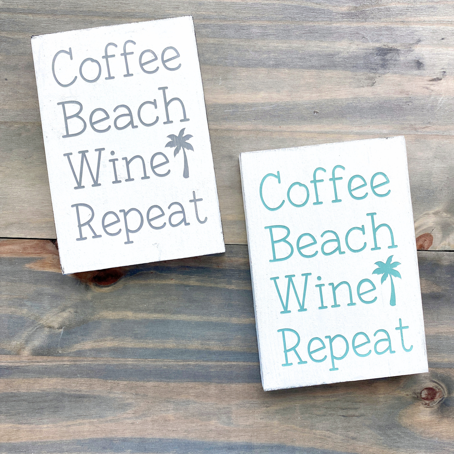 Two signs with 'Coffee Beach Wine Repeat' text on a wooden surface