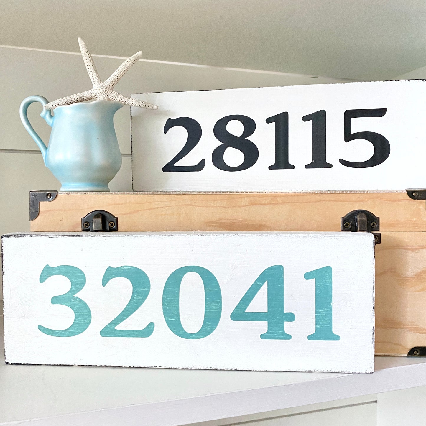Wooden signs with custom zip codes '28115' and '32041' on a white background.