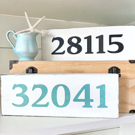 Wooden signs with custom zip codes '28115' and '32041' on a white background.