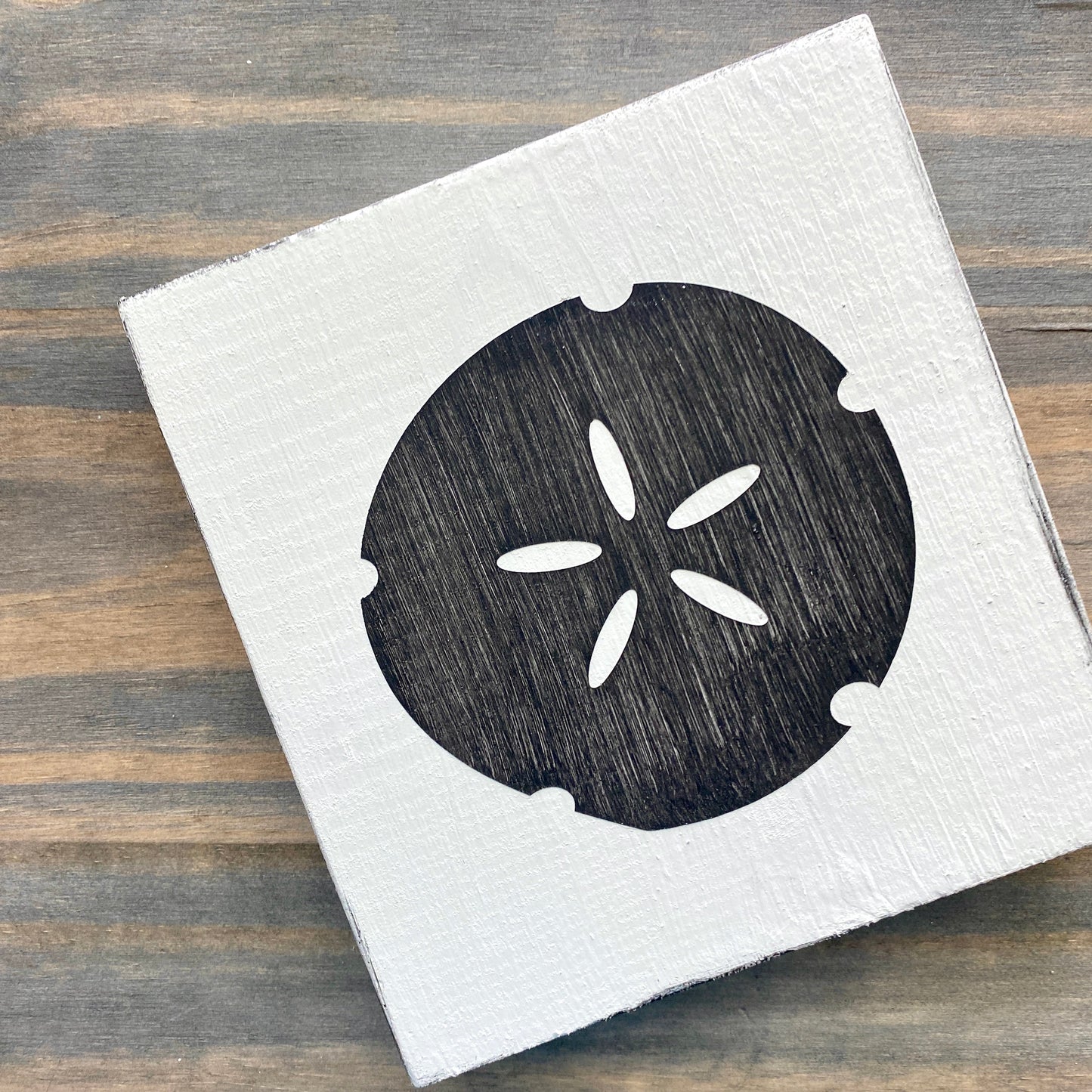 Sand dollar beach sign on wood in black with white background
