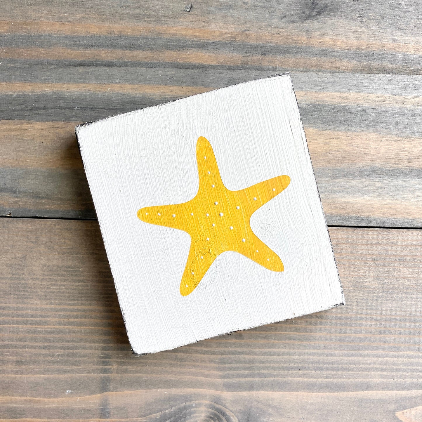 Starfish beach sign on real wood, coastal decor displayed in yellow